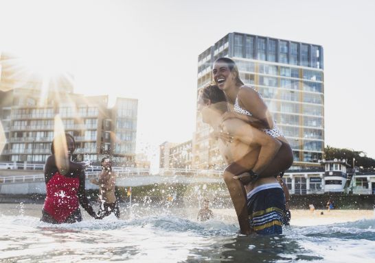 Friends enjoying a swim at Newcastle Beach, Newcastle